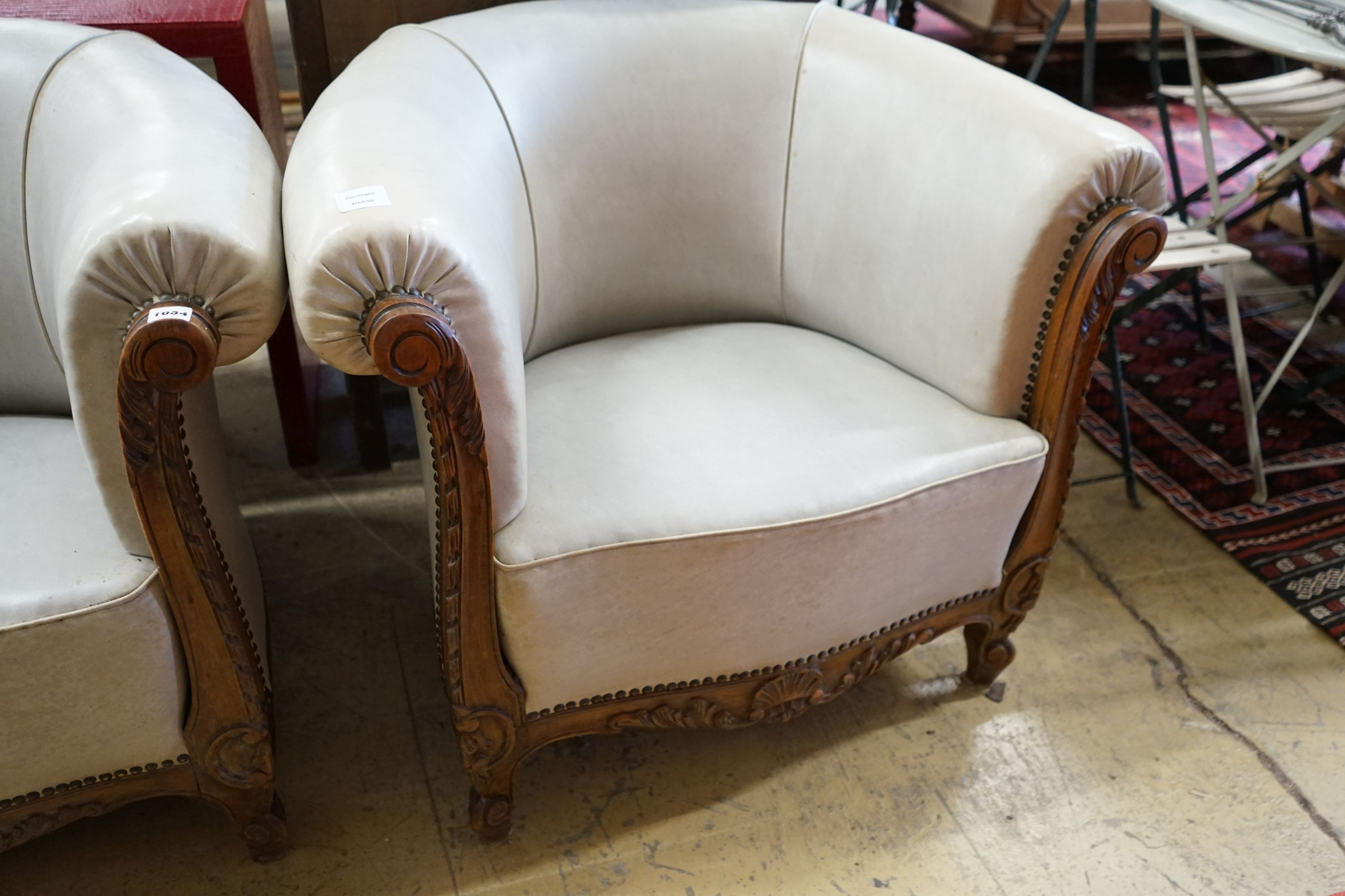 A pair of leather upholstered continental tub chairs, width 88cm, depth 70cm, height 72cm